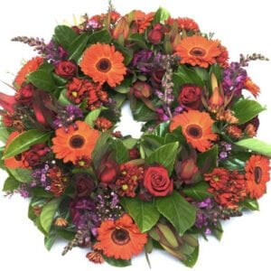 red and orange funeral wreath