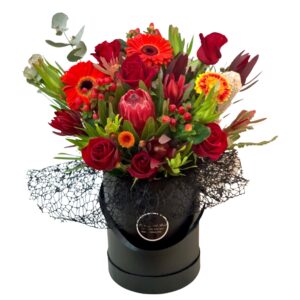 red roses gerberas proteas hat box