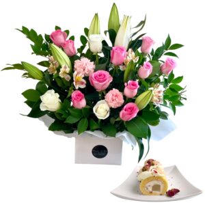 white flowers in vase and cake