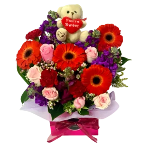 orange and red flower box with Teddy Bear